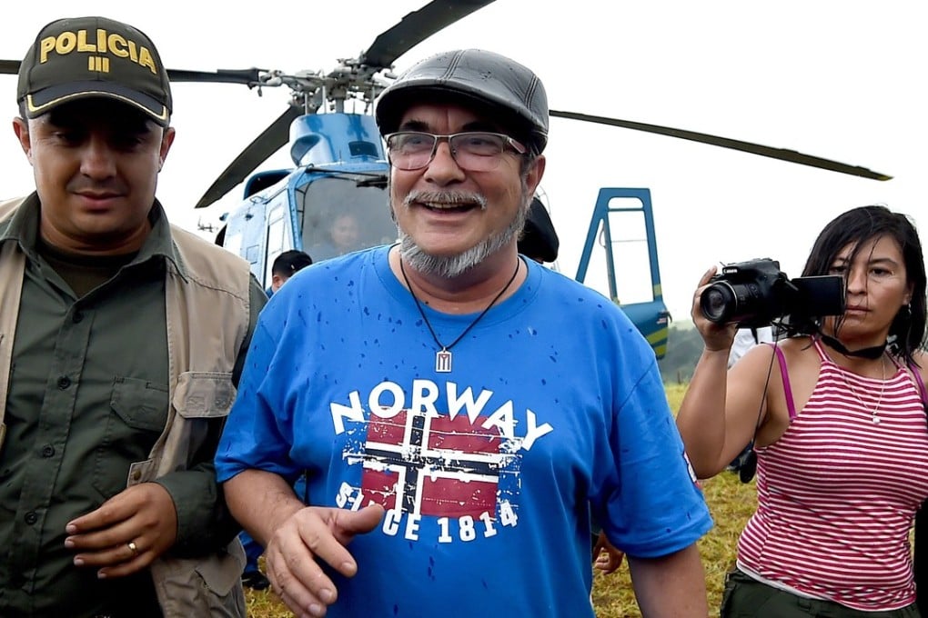 FARC rebel leader Rodrigo Londono Echeverri (centre), better known as "Timochenko", alights from a helicopter during the group’s final act of abandonment of arms and its end as an armed group last week. Photo: AFP