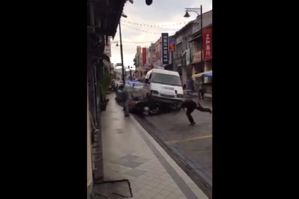 The 18-second video showed three cars in pursuit of a van along the road, with pedestrians scrambling to get out of the way. Photo: New Straits Times