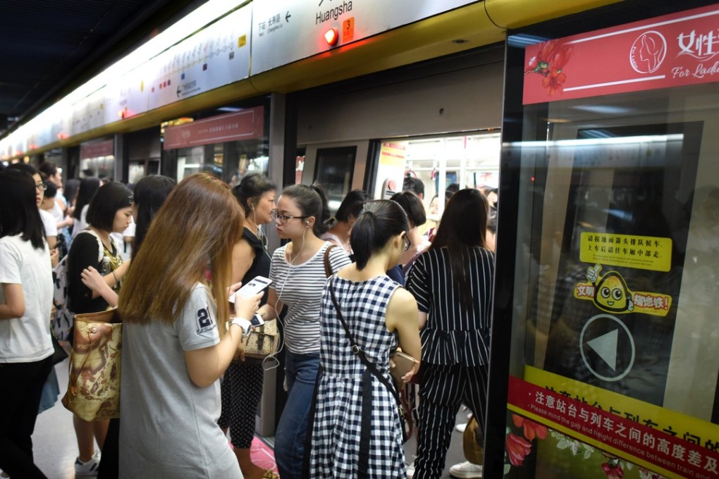Women enter a priority carriage at a subway station in Guangzhou. The dedicated compartments were introduced on June 28, but a study has questioned their value. Photo: Xinhua