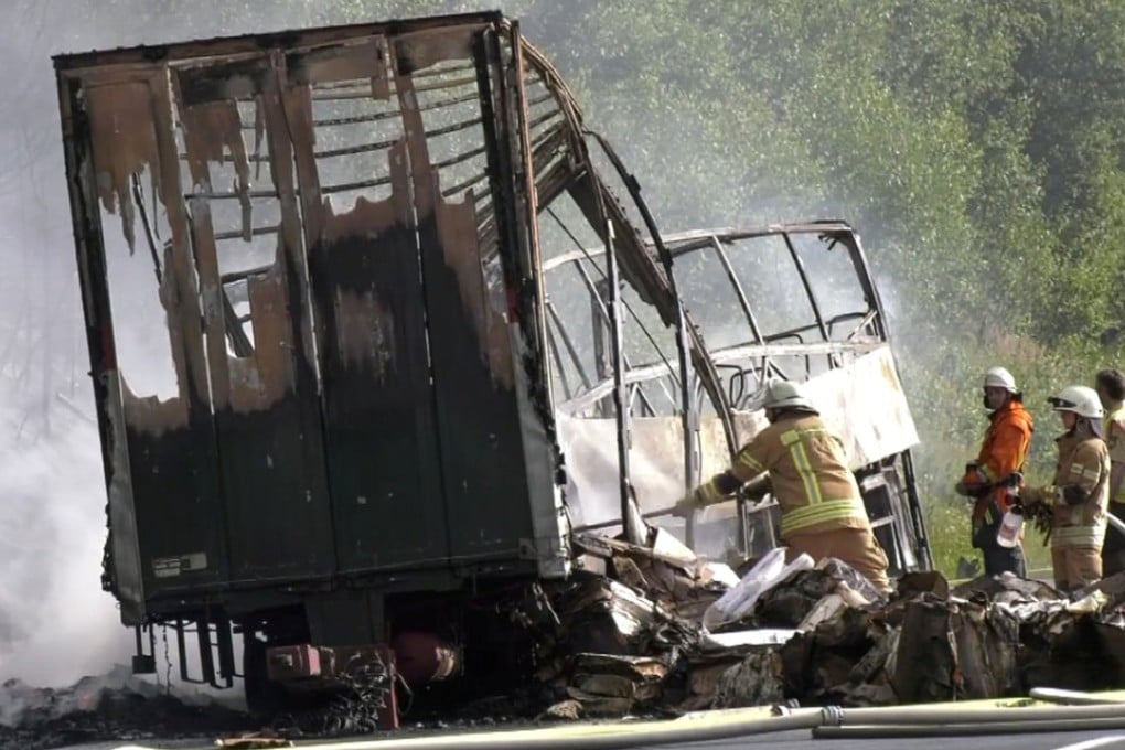 Firefighters at the site of the coach crash. Photo: Reuters
