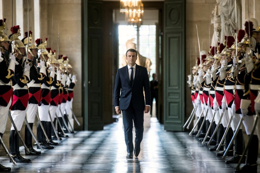 French President Emmanuel Macron walks through the Galerie des Bustes to access the Versailles Palace's hemicycle for a special congress gathering both houses of parliament. Photo: Reuters