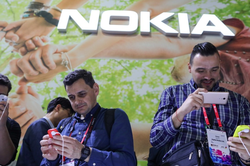 Visitors test out Nokia 3310 mobile phones at the Mobile World Congress in Barcelona, Spain, on February 27, 2017. The brand is making a renewed push in China, focusing on digital health and VR. Photo: Bloomberg