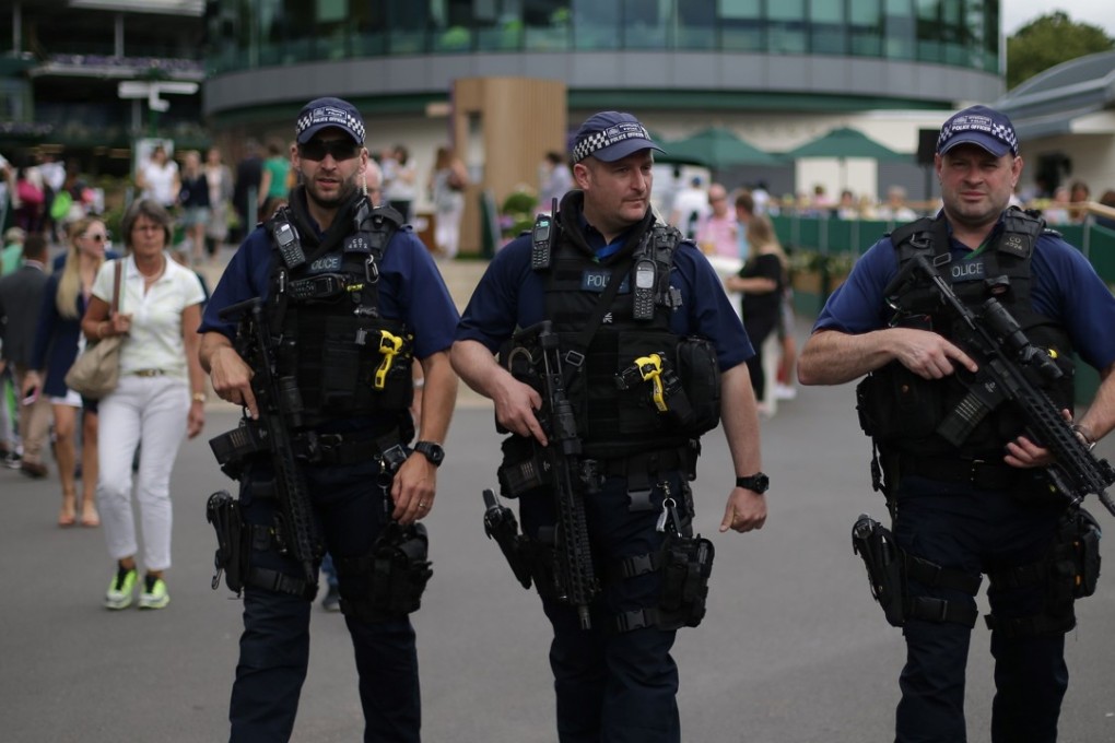 Armed British Police officers patrol at The All England Lawn Tennis Club in Wimbledon, as security was increased following a string of terrorist attacks. Photo: AFP