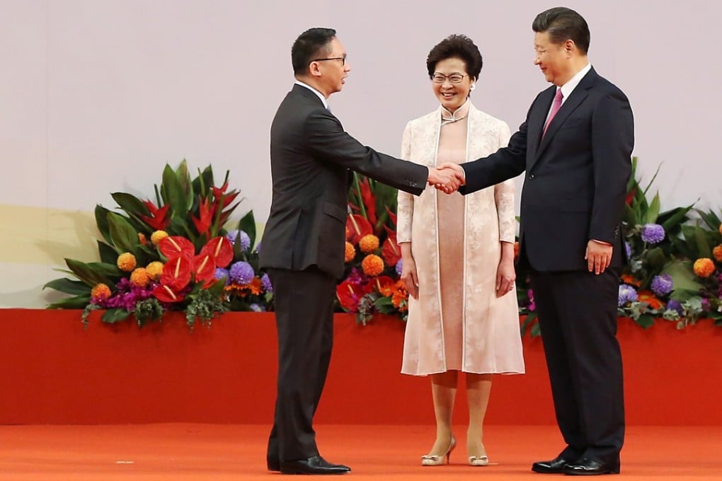 Rimsky Yuen Kwok-keung (left), reappointed as Hong Kong’s Secretary for Justice, shakes hands with President Xi Jinping on July 1, while Chief Executive Carrie Lam Cheng Yuet-ngor looks on. Photo: Sam Tsang