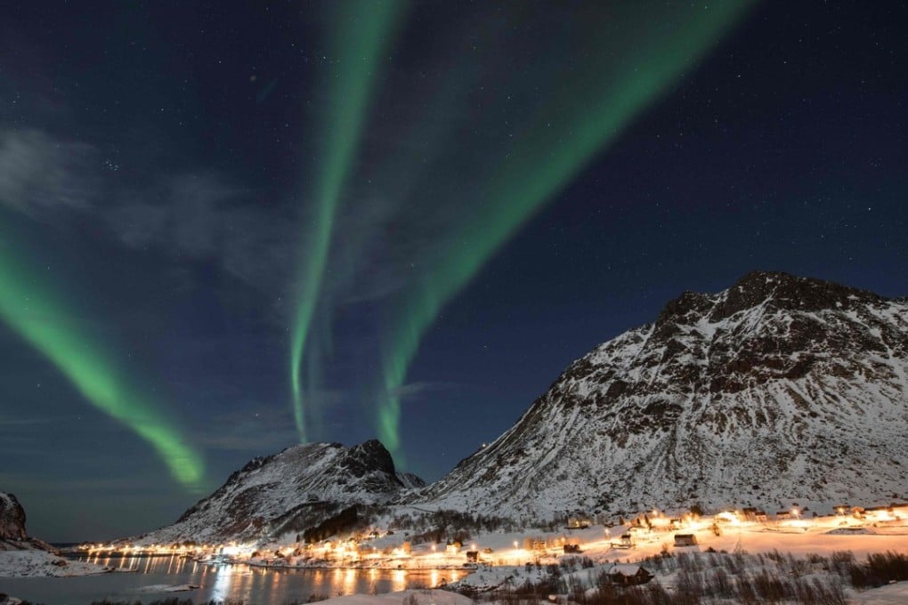 The “Northern Lights”, also known as “Aurora borealis” flash across the sky above Unstad in Norway, a town know for being the world's most northern Arctic surf school. AFP