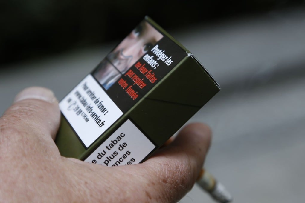 A man smokes a cigarette in Paris, as the government considers raising the price of a pack of cigarettes to 10 euros from the current 7 euros to break the habit which is causing 80,000 tobacco-related deaths a year. Photo: AFP
