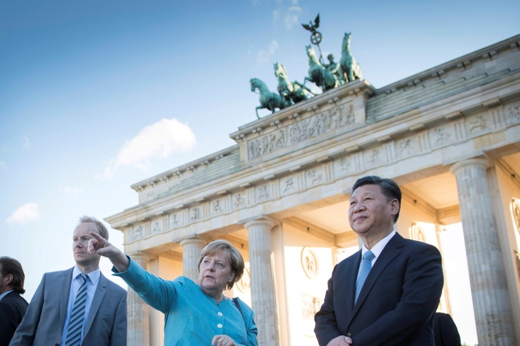 German Chancellor Angela Merkel guides President Xi Jinping around the Brandenburg Gate in Berlin, Germany, on Tuesday. Photo: Reuters