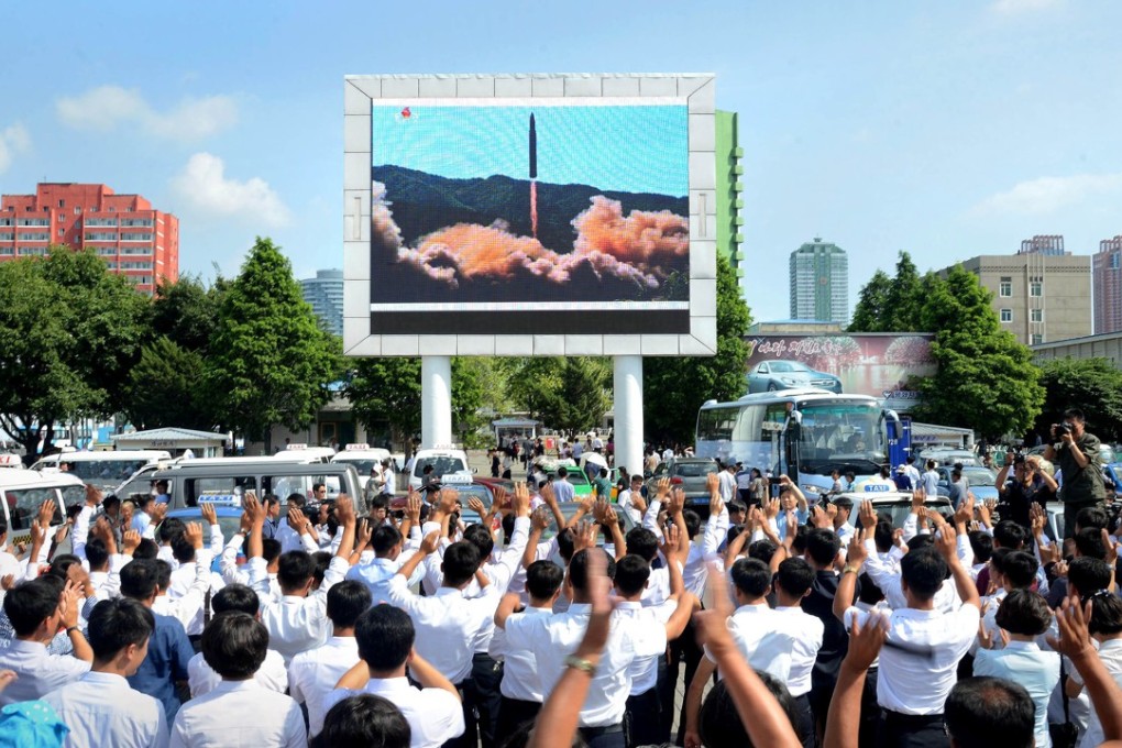 People in North Korea watch the test launch of intercontinental ballistic missile Hwasong-14 in this undated photo released by North Korea's Korean Central News Agency. Photo: Reuters