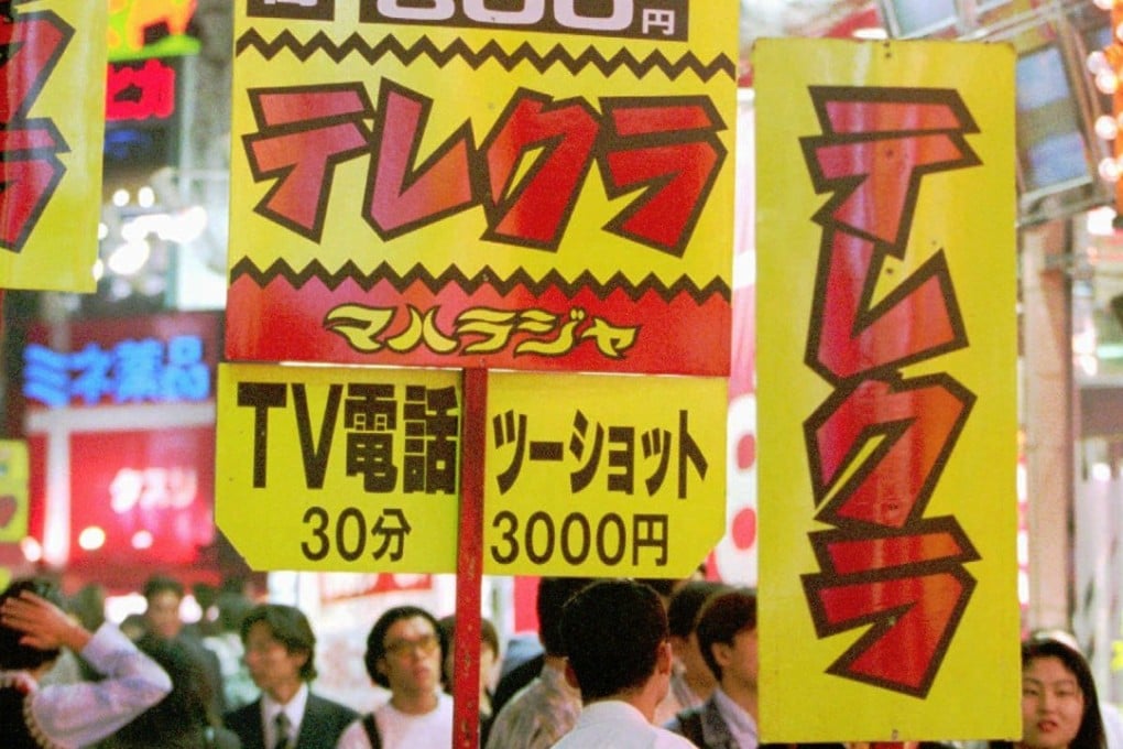 Signboards advertising so-called "telephone clubs" where girls chat with potential customers and sometimes arrange meeting that lead to sex for money. Photo: AP