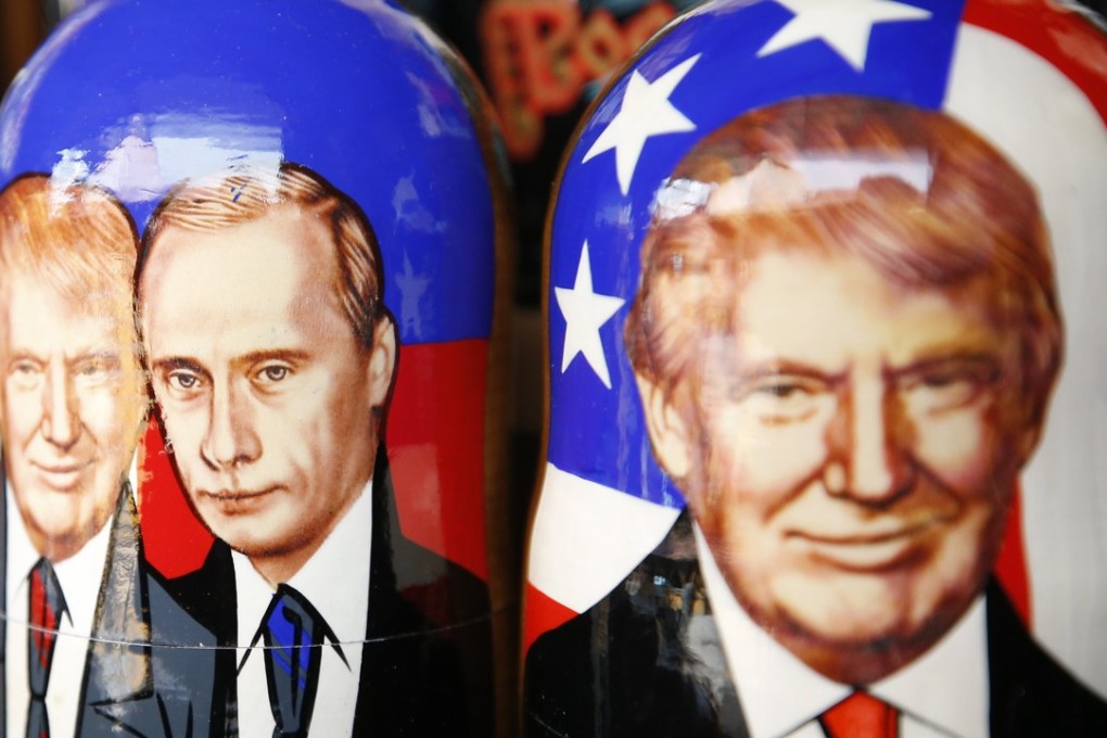 Traditional Russian Matryoshka wooden dolls are illustrated with the images of US President Donald Trump and Russian President Vladimir Putin at a gift shop in Moscow. Photo: EPA