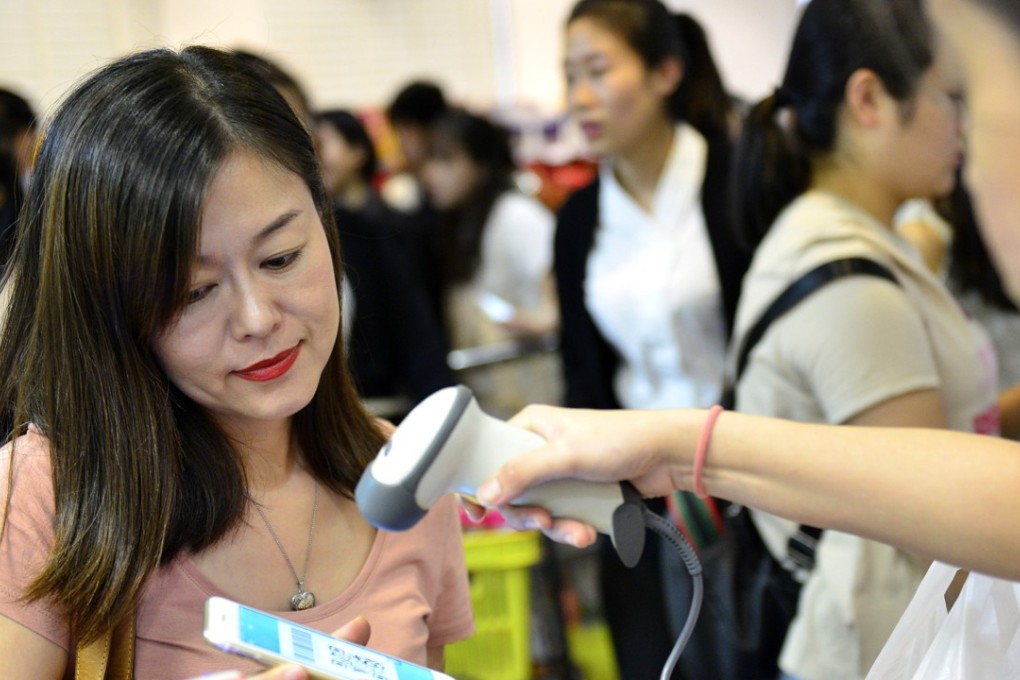 A customer pays with Alipay at a department store in Singapore. Photo: Xinhua