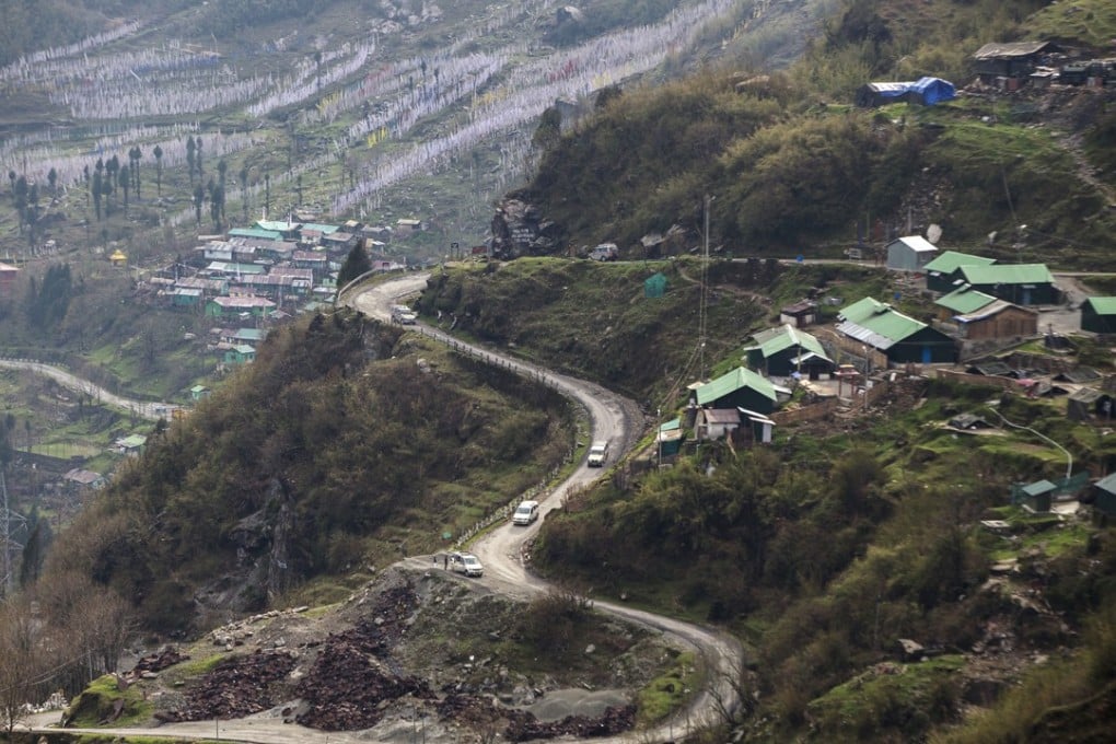 Vehicles travel along a mountain road near the Nathu La Pass, a trading post in the Himalayas between India and China in the state of Sikkim. Photo: Bloomberg