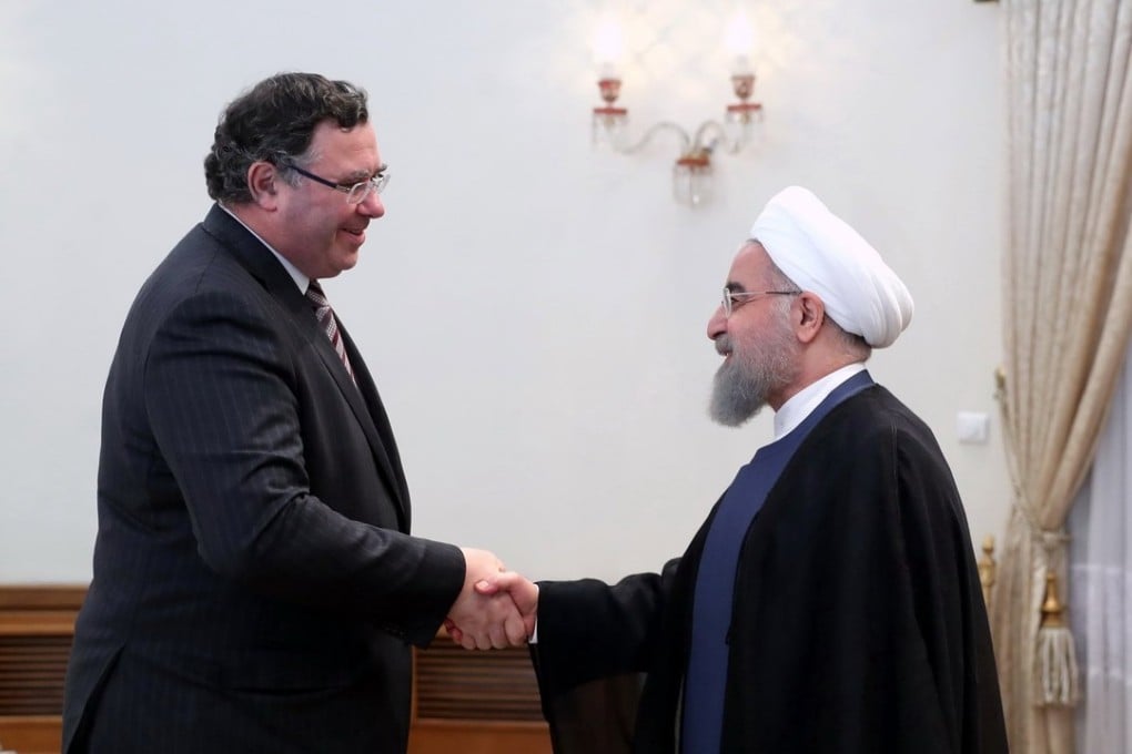 Iranian president Hassan Rowhani greeting Total's chief executive, Patrick Pouyanne, at the presidential office in Tehran. Photo: EPA