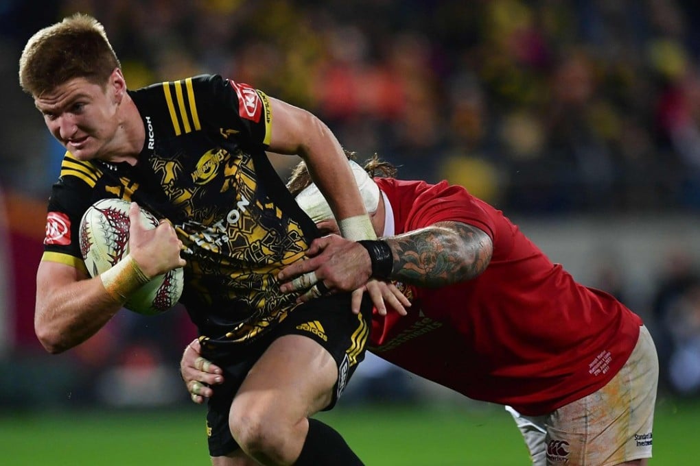 Wellington Hurricanes' Jordie Barrett is tackled by British & Irish Lions’ Joe Marler. Photo: AFP