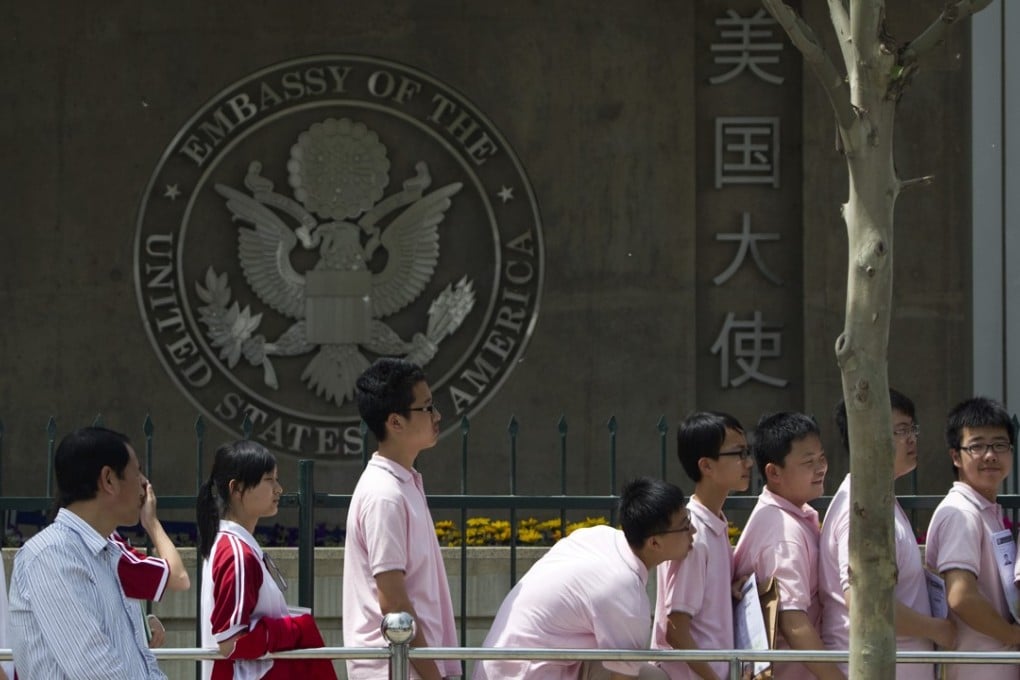 Chinese students wait outside the US Embassy in Beijing for their visas. Photo: AP