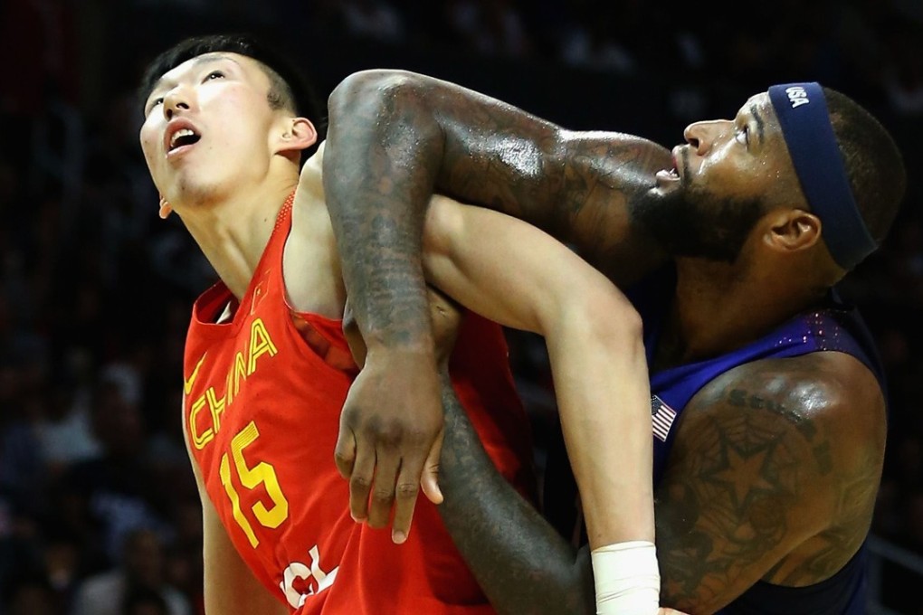 Zhou Qi wrestles with DaMarcus Cousins during an exhibition game between China and the USA before last summer’s Olympics. Photo: AFP
