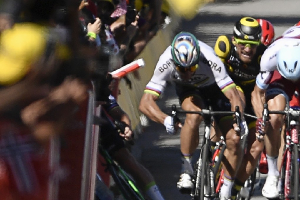 Slovakia's Peter Sagan (2ndL) gives a kick of his elbow into Great Britain's Mark Cavendish (L), who falls near the finish line at the end of the 207,5 km fourth stage of the 104th edition of the Tour de France. World champion Sagan was sensationally kicked off the Tour and his appeal was rejected by the Court of Arbitration for Sport. Photo: AFP