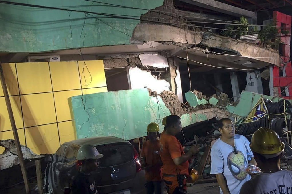 Rescuers conduct search operations in a damaged building in Kananga, Leyte province. Photo: EPA
