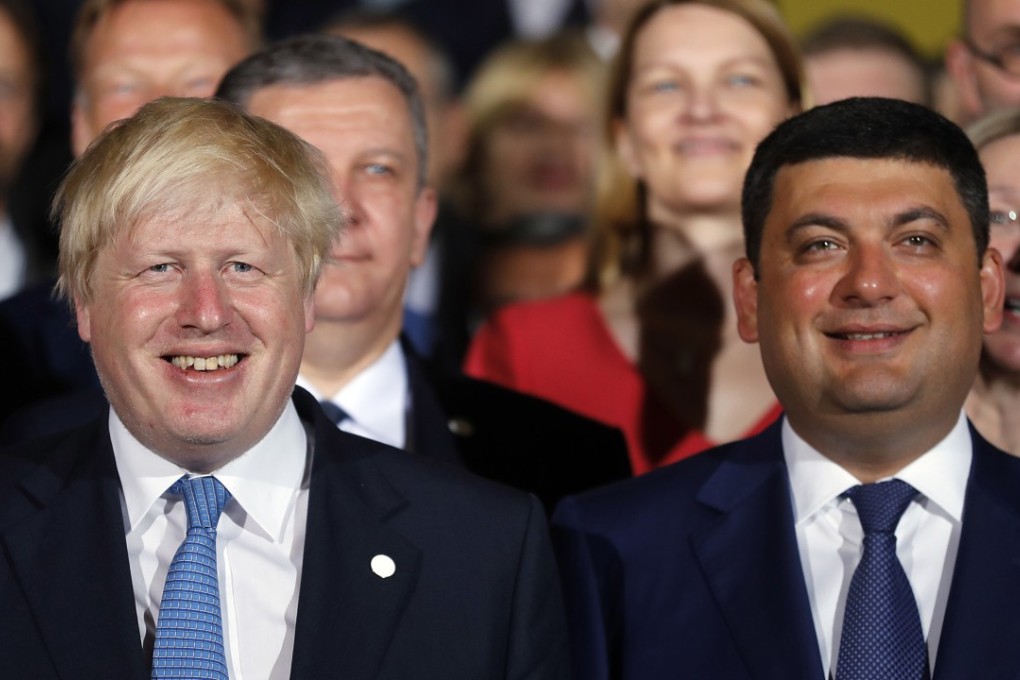 Ukraine's Prime Minister Volodymyr Groysman, right, and Britain's Secretary of State for Foreign and Commonwealth Affairs Boris Johnson pose for a family photo ahead of a Ukraine Reform Conference at Lancaster House in London on Thursday. Photo: AP