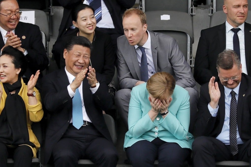 President Xi Jinping (second from left) and his wife Peng Liyuan (left) watch an under-12 soccer game with German Chancellor Angela Merkel (third from left), in Berlin last week. Xi’s love of the game is well known. Photo: EPA