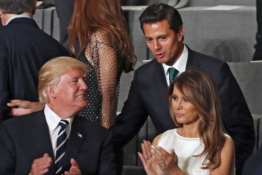 Mexican President Enrique Pena Nieto talks to US President Donald Trump and his wife Melania Trump. Photo: EPA