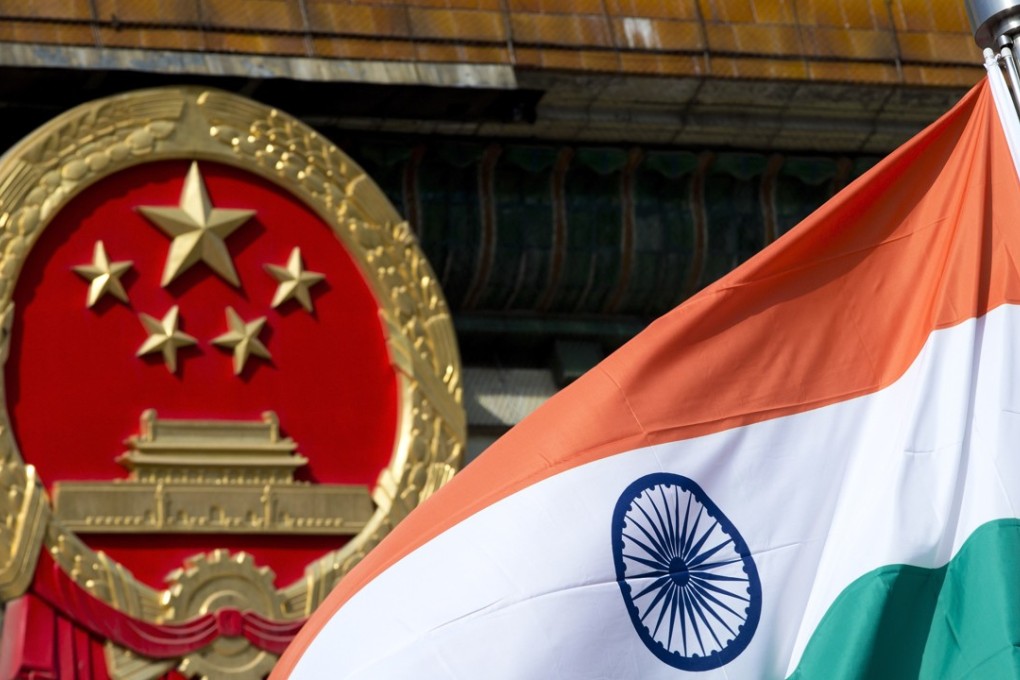 An Indian national flag is flown next to the Chinese national emblem outside the Great Hall of the People in Beijing in this 2013 file photo. Photo: Associated Press