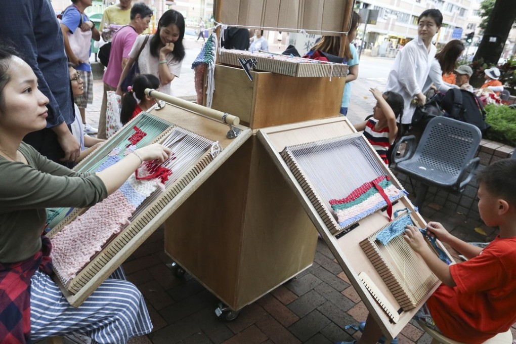 Members of the public are invited to have a go at traditional weaving and textile art, to appreciate the craftsmanship of an industry that is fast fading. Photo: Jonathan Wong