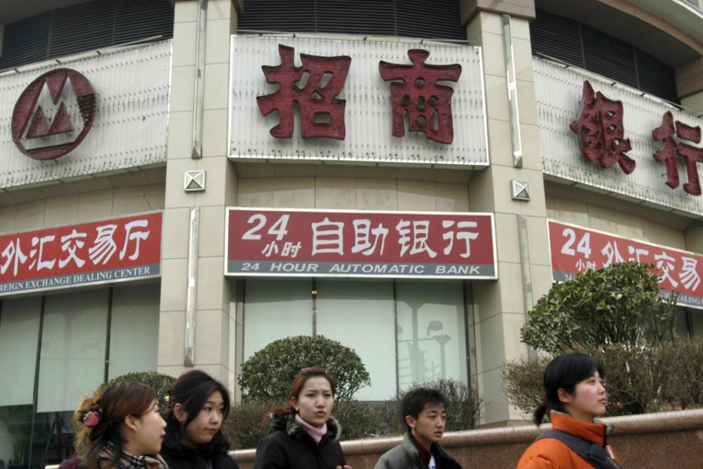 People walk past a China Merchants Bank during lunch hours in Beijing, China on Wednesday, February, 18, 2004. Photographer: Photo: Bloomberg