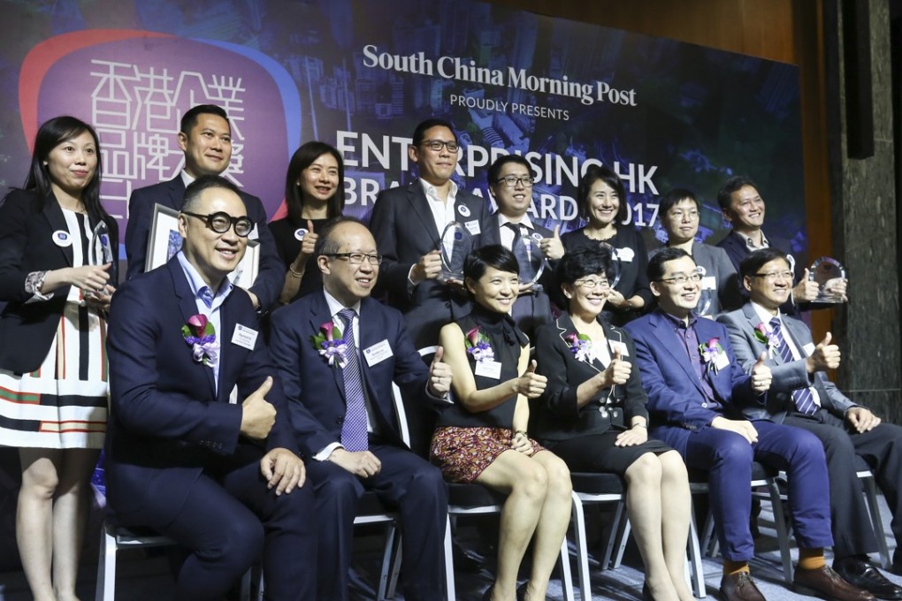 (front row left to right): Chairman of The Hong Kong Advertisers Association, Raymond Ho; Director, Business Management of Hong Kong Productivity Council, Gordon Lo; Marketing Director, Brand Marketing of South China Morning Post, Irene Yuen; Vice President (Student and Global Affairs) of The Hong Kong Polytechnic University, Angelina Yuen; Executive Director of Hong Kong Design Centre, Edmund Lee; Deputy Executive Director of Hong Kong Trade Development Council, Raymond Yip; (back row left to right): Customer & Brand Engagement Manager of CLP Power Hong Kong Ltd., Kathy Tang; Director, Service Delivery of Hong Kong Airlines, Stanley Kan; Head of Branding & Marketing Communications of Hutchison Telecommunications, Winnie Ho; Executive Director of Lan Kwai Fong Group,Fergus Fung; Administration Manager of German Pool 020 Limited, Karin Yup; General Manager, Distribution and Marketing of Sun Life Financial, Belinda Au; Founder & Chief Executive Officer of HOHOLIFE, Aries Lee; and Technic