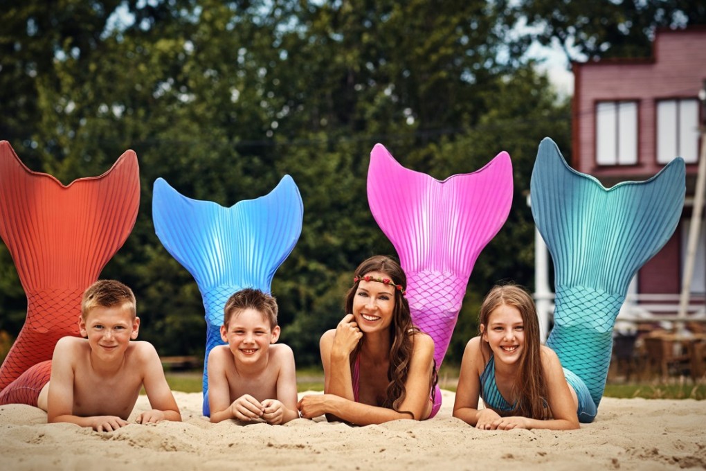 Katrin Gray (second right), aka Mermaid Kat, runs three academies that teach aspiring merfolk how to swim and act like the aquatic creatures. Photo: Jan Langmaack