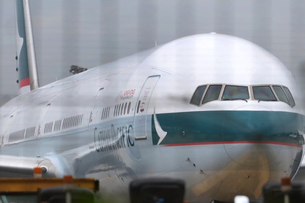 Cathay Pacific flight is seen at the Hong Kong International Airport. The Airlines said 600 of 3000 head office jobs would be axed. Photo: SCMP/Felix Wong