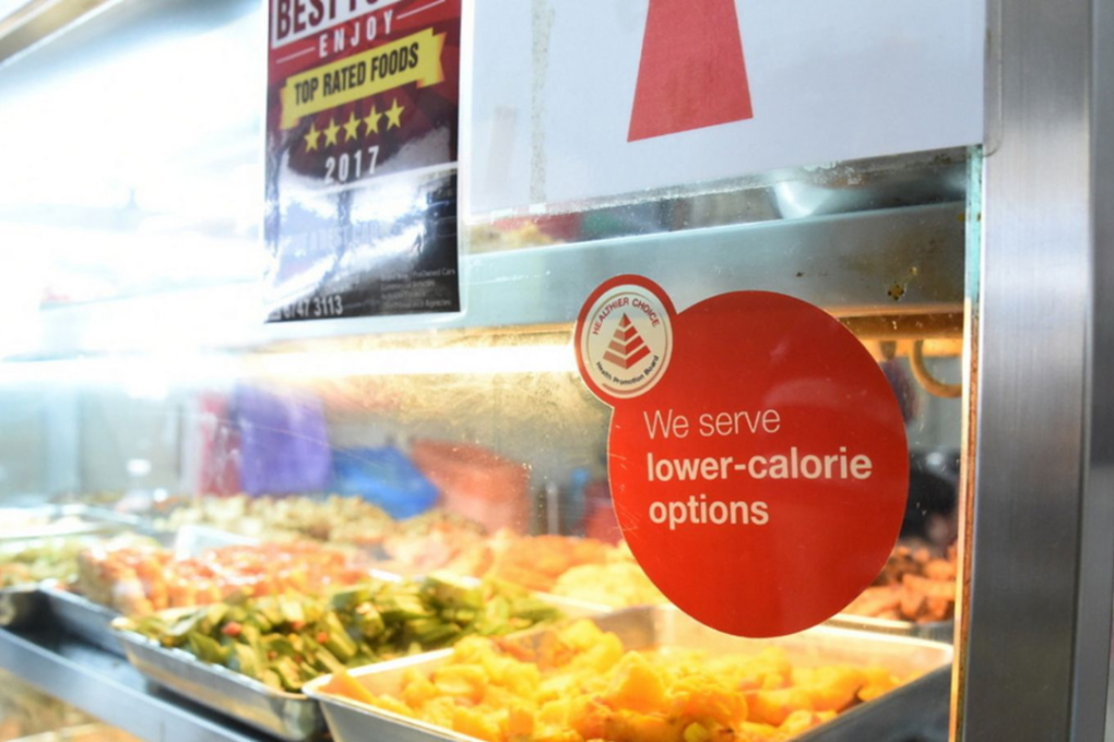 Singaporeans can identify stalls with healthier food options through labels. These meals are 500 calories and below, compared with between 700 and 800 calories for other meals. Photo: Health Promotion Board