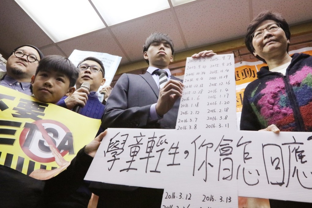 Then chief executive hopeful Carrie Lam is given a cross bearing the dates of student suicides, as the government is urged to help prevent the tragedies, in Mong Kok on February 19. Photo: Felix Wong