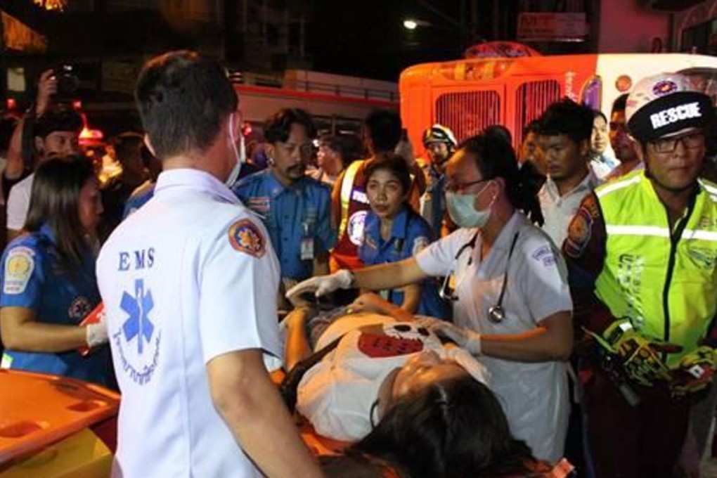 An injured passenger is treated after the driver of a tour bus lost control and it overturned on Monday night. Photo: Handout