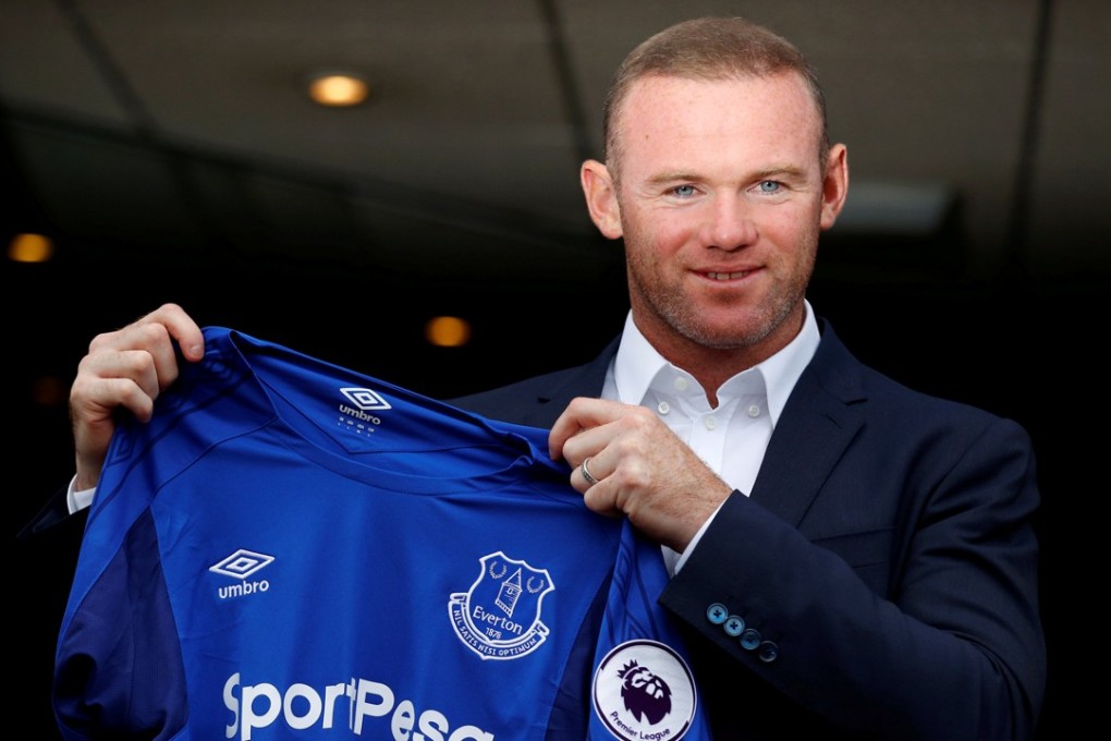 Everton's Wayne Rooney poses with the club shirt. Photo: Reuters