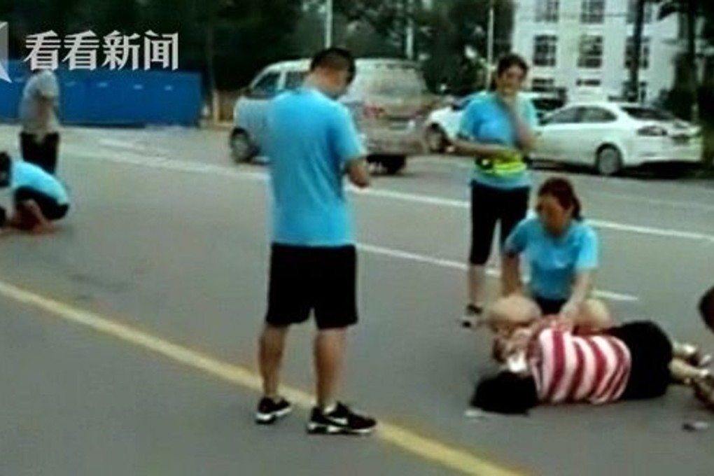 People tend to the injured after a taxi ploughed into a group of joggers in Shandong. Photo: Handout