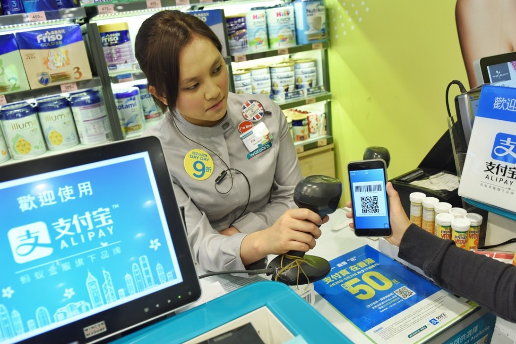 A staff worker tests AlipayHK at a store in Hong Kong. US payments provider Stripe has struck partnerships with Alipay and WeChat Pay. Photo: Xinhua