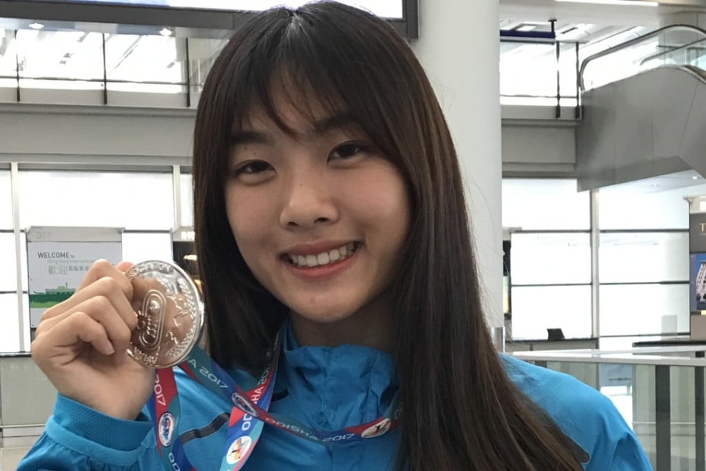 Cecilia Yeung Man-wai with her silver medal after arriving back in Hong Kong. Photos: Chan Kin-wa