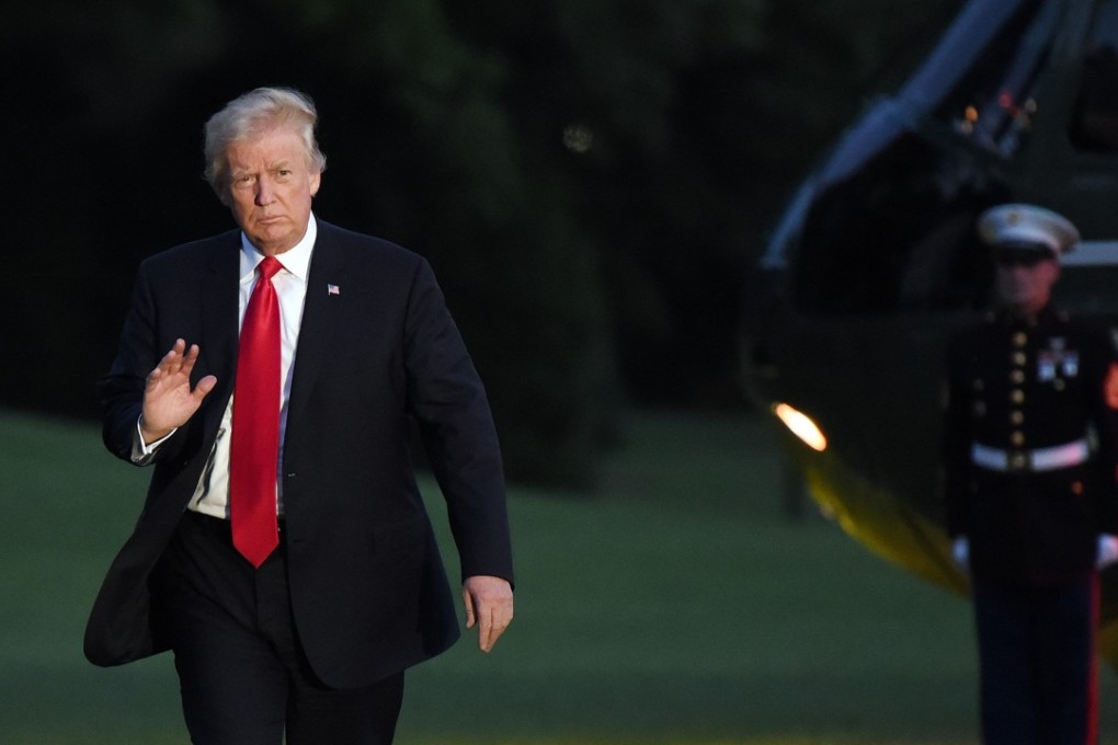 US President Donald Trump waves as he returns to the White House after the G20 summit meeting in Germany. Photo: Bloomberg