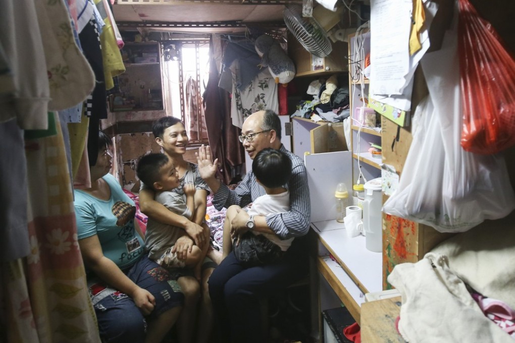 Secretary for transport and housing, Frank Chan Fan makes home visits with the Society for Community Organisation in Sham Shui Po. Photo: David Wong