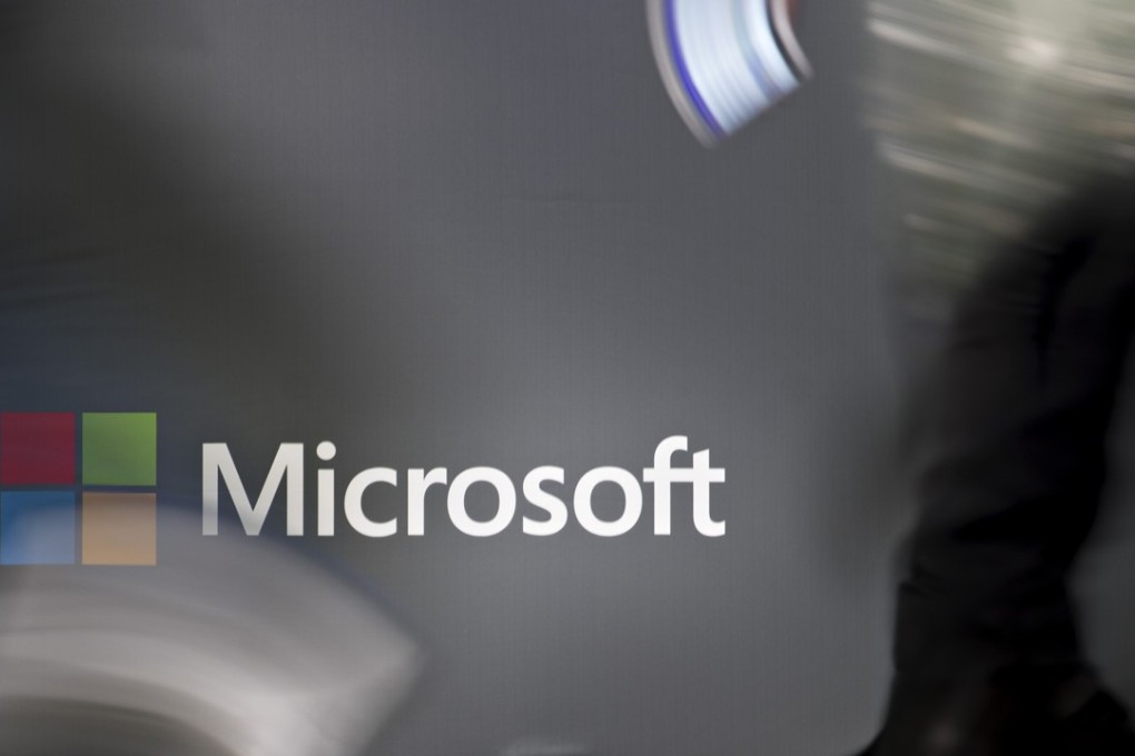 Attendees walk past signage in the exhibition hall during the Microsoft Inspire partner conference at the Verizon Centre in Washington, DC. The tech giant is proposing a broadband initiative to connect rural Americans. Photo: Bloomberg