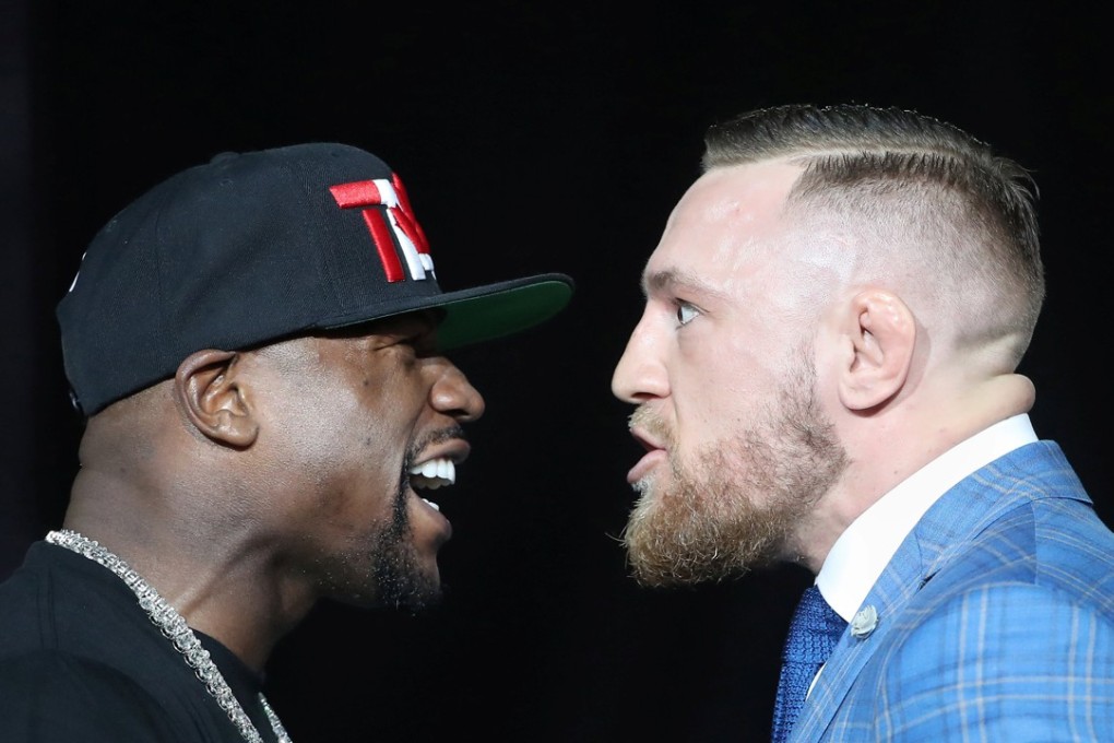 Floyd Mayweather and Conor McGregor stare each other down during their world tour press conference. Photo: USA Today
