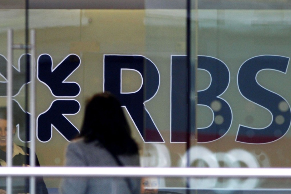 A customer walks into a branch of the Royal Bank of Scotland building in London. The bank is paying a settlement for mis-selling mortgage backed securities in the US going back to the global financial crisis. Photo: AFP