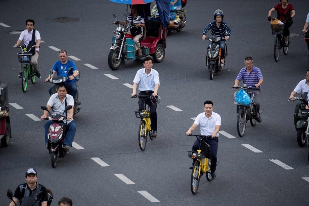 Two men (centre) ride bicycles from a bike sharing company. As of April, as many as 520,000 shared bikes were reportedly put into service in Shenzhen. Photo: AFP
