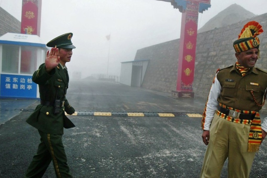 A Chinese soldier gestures near an Indian soldier on the China-India border in this file photo. A border dispute between the two countries risks damaging the upcoming BRICS summit. Photo: AFP