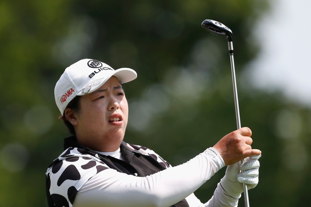 Feng Shanshan watches her tee shot on the fourth hole. Photo: AFP