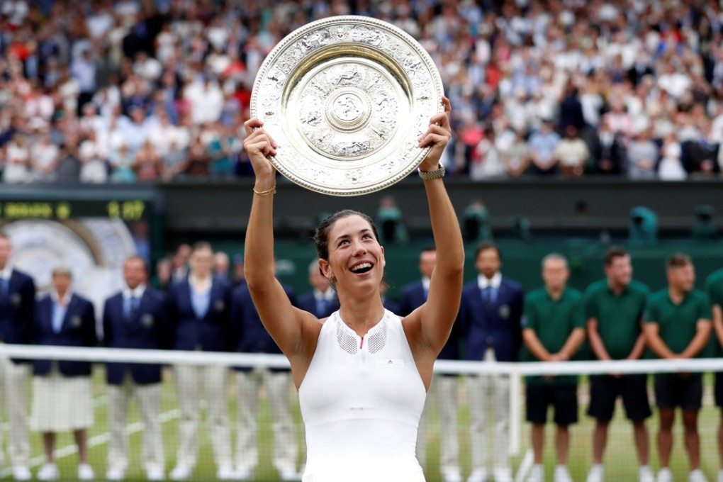 Spain’s Garbine Muguruza raises the trophy after winning the Wimbledon women’s singles title. Photo: Reuters