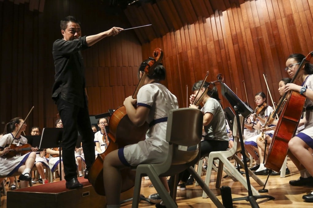 Artistic director Leung Kin-fung conducting the Diocesan Girls’ School Orchestra in Jordan. Photo: Jonathan Wong