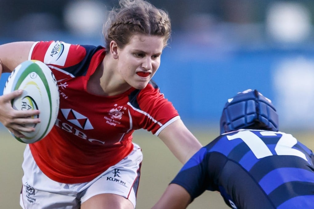 Hong Kong youngster Kelsie Bouttle fends off her opponent in her side’s loss to Japan. Photos: HKRU