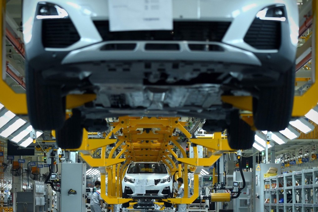 Assembly line workers at PSA Peugeot Citroen’s factory in Wuhan putting together a Peugot 4008 sports utility vehicle in September 2016. China last year produced 24 million cars, surpassing the US as the world’s largest vehicle making country. Photo: AFP